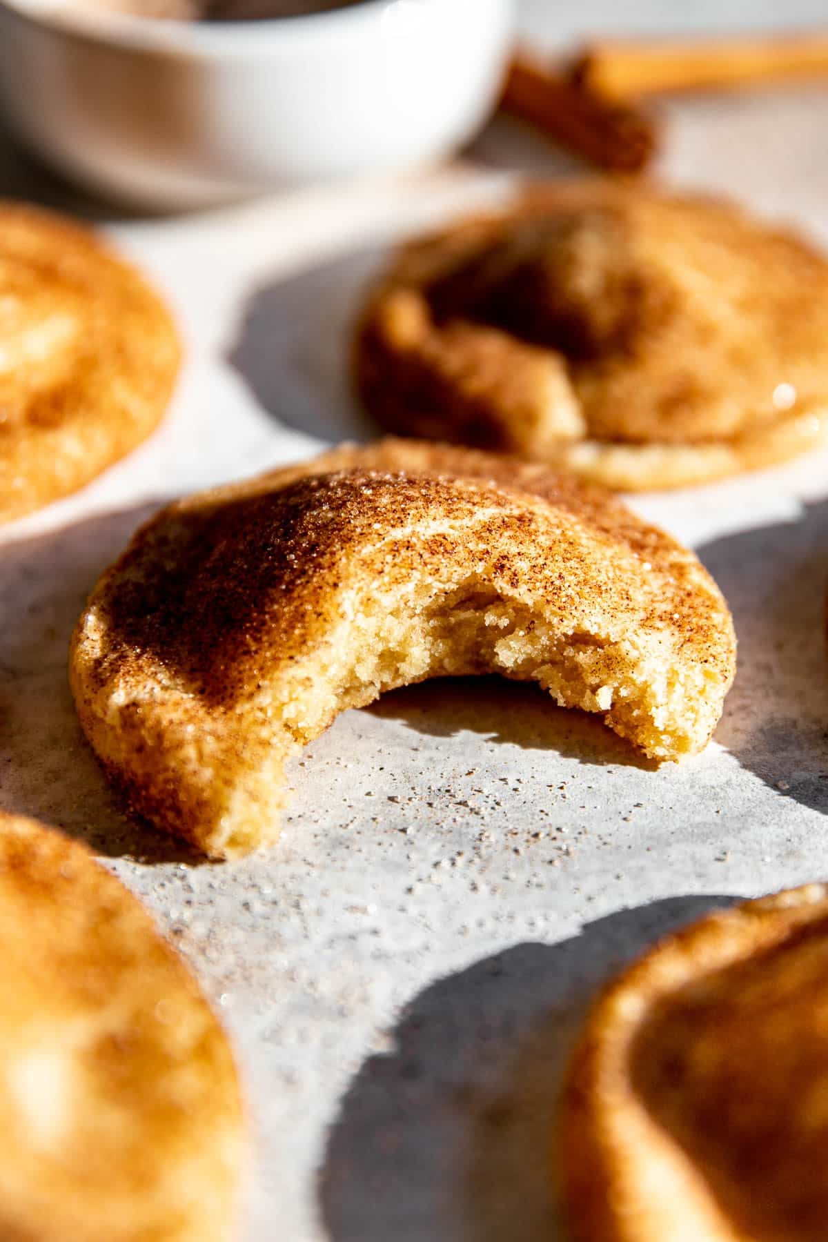 a bite taken out of a snickerdoodle cookie.