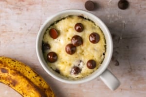 a freshly made mug cake with chocolate chips on top.