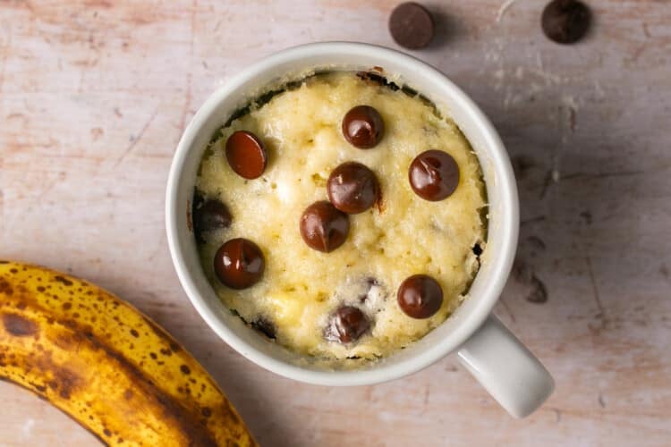 a freshly made mug cake with chocolate chips on top.