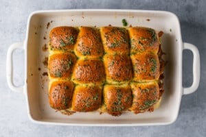 freshly baked sliders in a white baing dish.