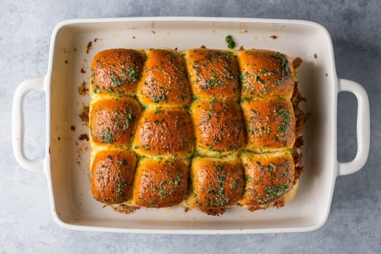 freshly baked sliders in a white baing dish.