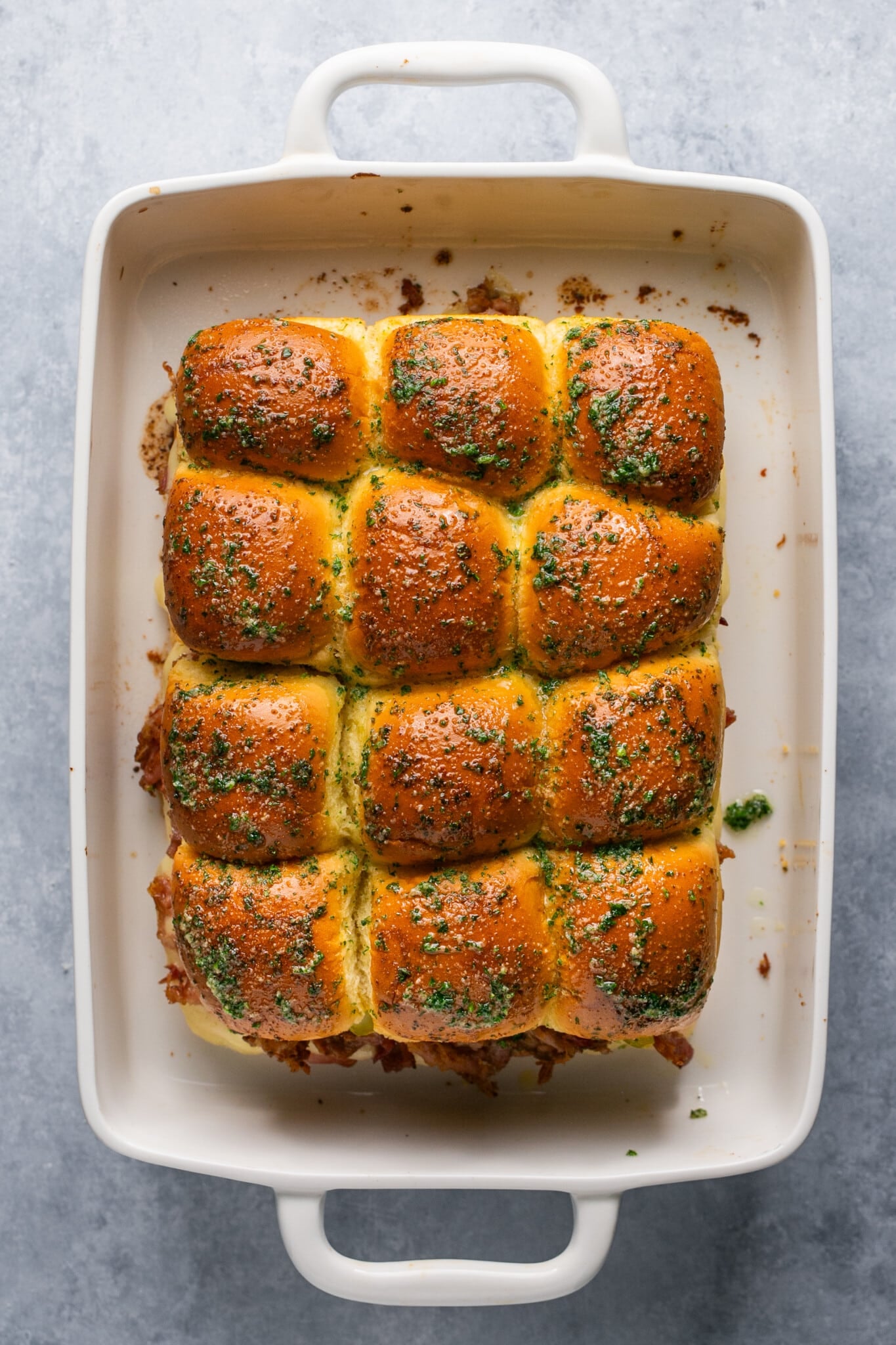 sliders in a white baking dish. 