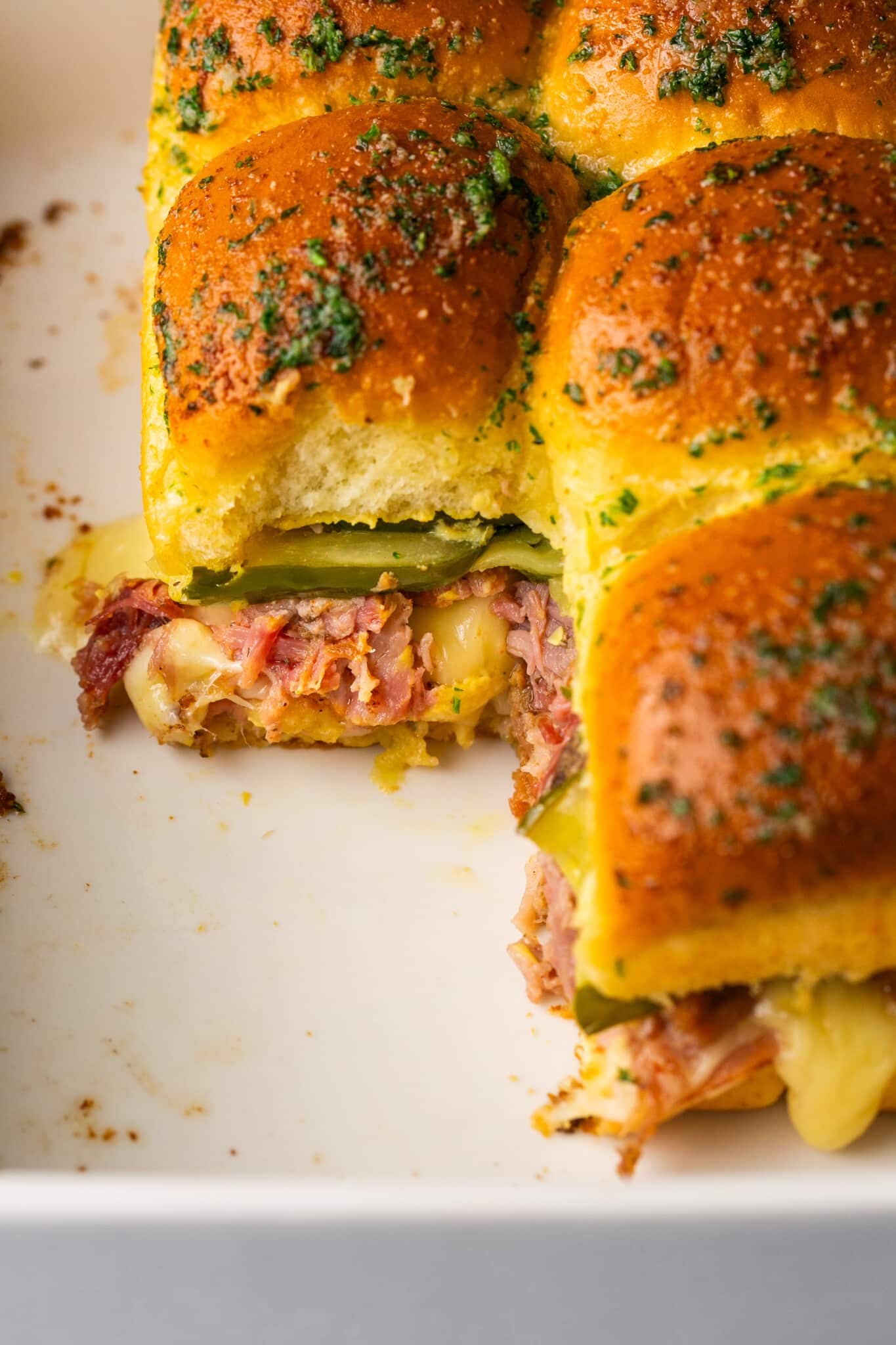 cuban sliders filled with pulled pork, ham, pickles and cheese. 