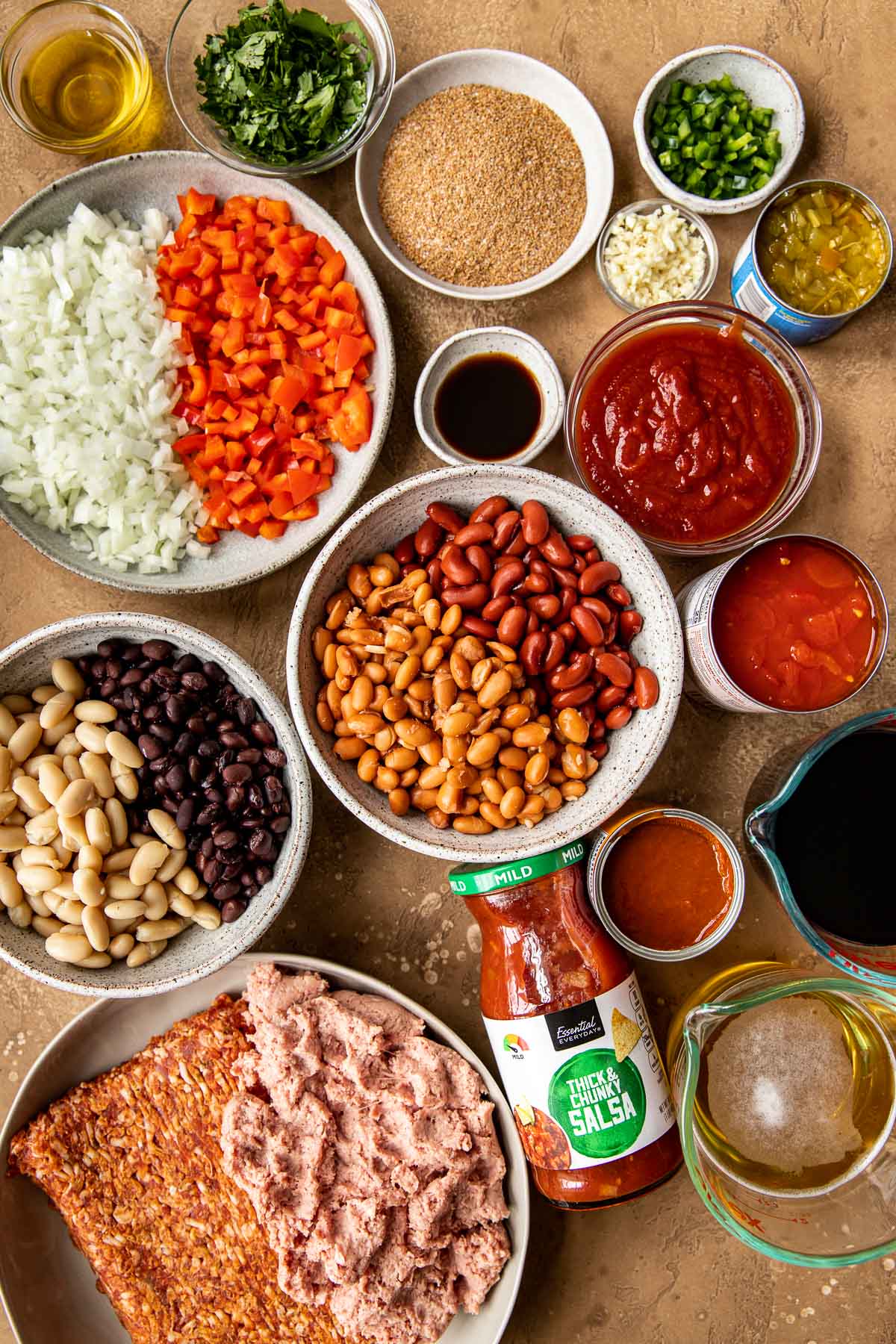 ingredients needed to make chili in some bowls. 