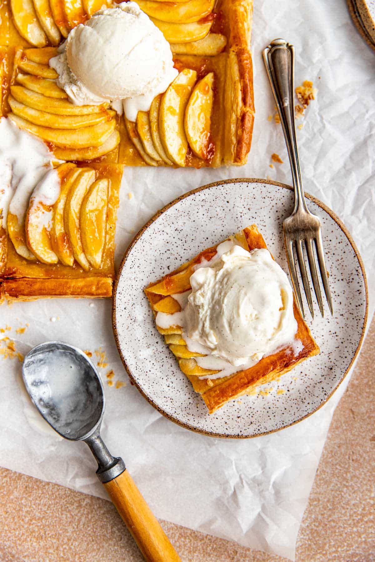 apple tart made with puff pastry served with vanilla bean ice cream on top. 
