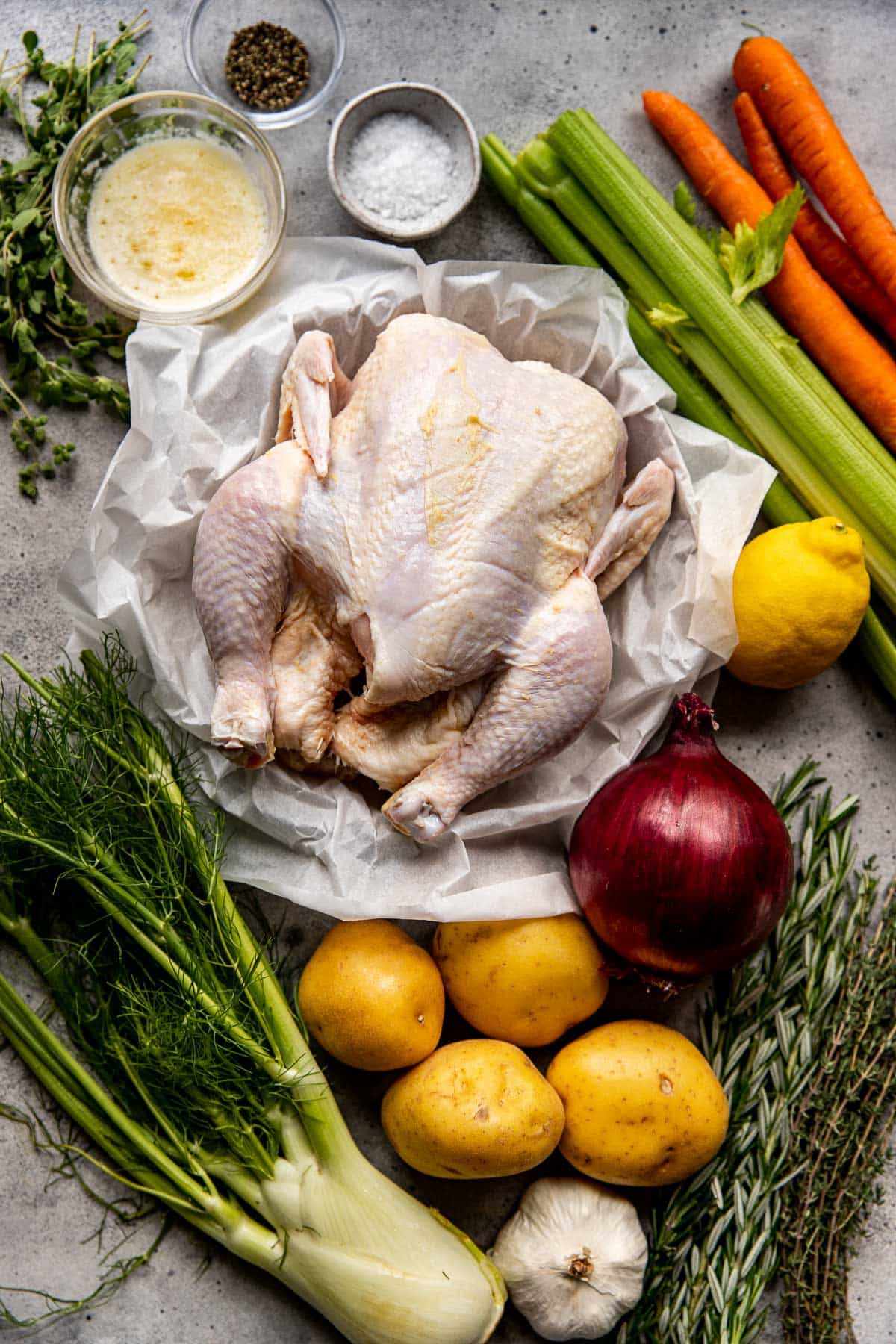 roast chicken with herbs, lemon, and vegetables. 