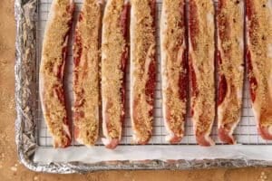 raw bacon with brown sugar on top to make candied bacon on a sheet pan.