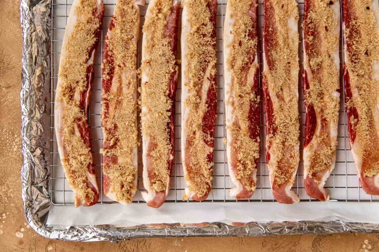 raw bacon with brown sugar on top to make candied bacon on a sheet pan.