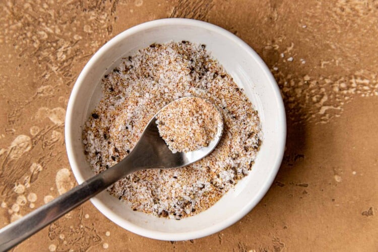 seasonings mixed together in a white glass bowl.