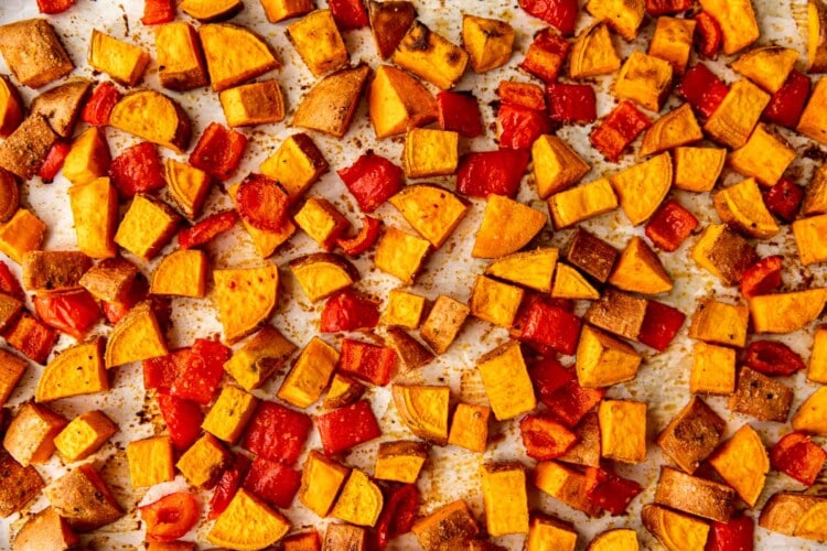 roasted sweet potatoes and bell peppers on a sheet pan.