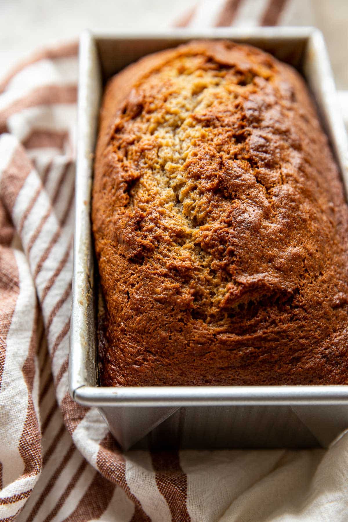 freshly baked banana bread in a loaf pan. 