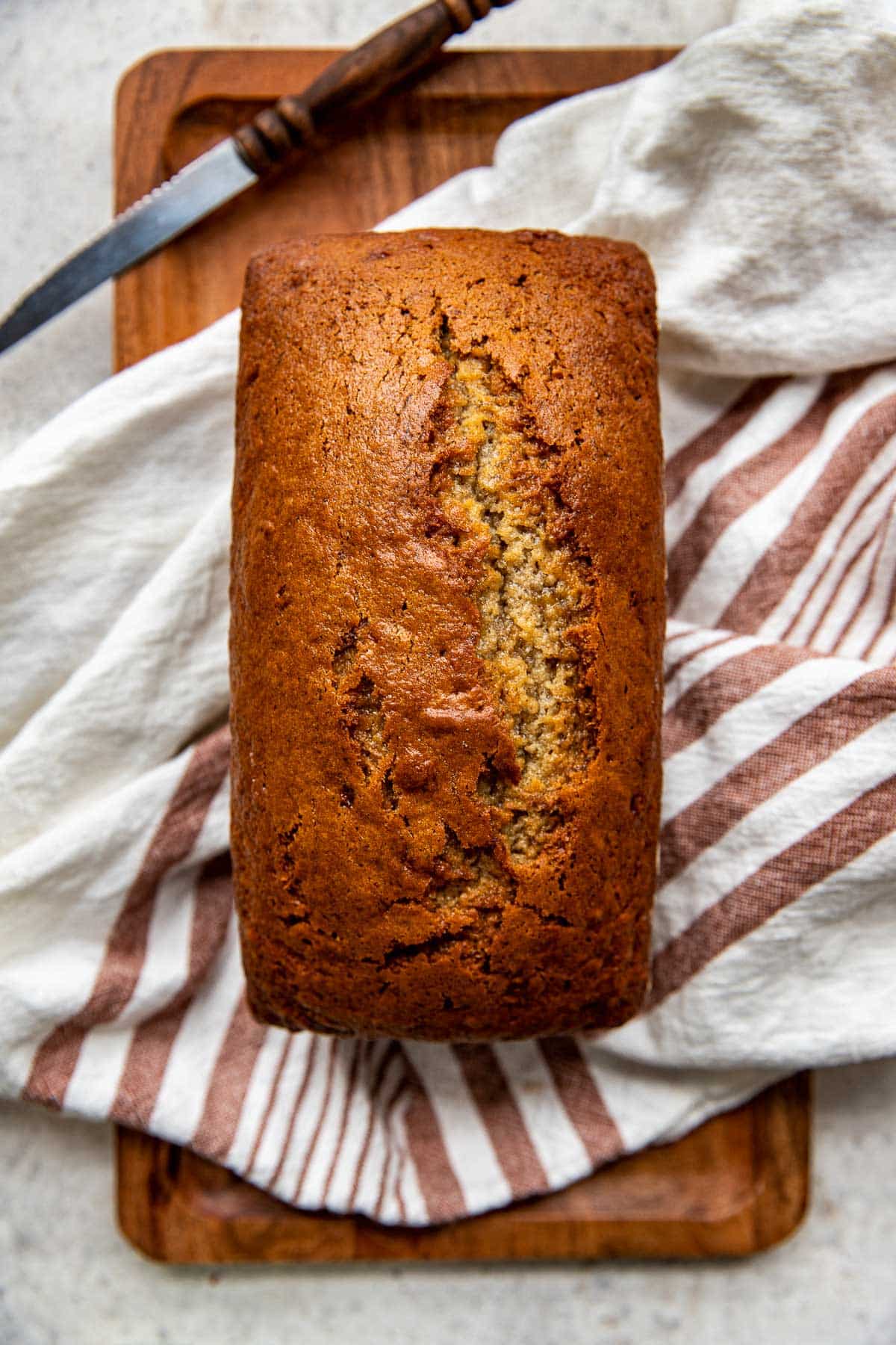 freshly baked banana bread on a cutting board.