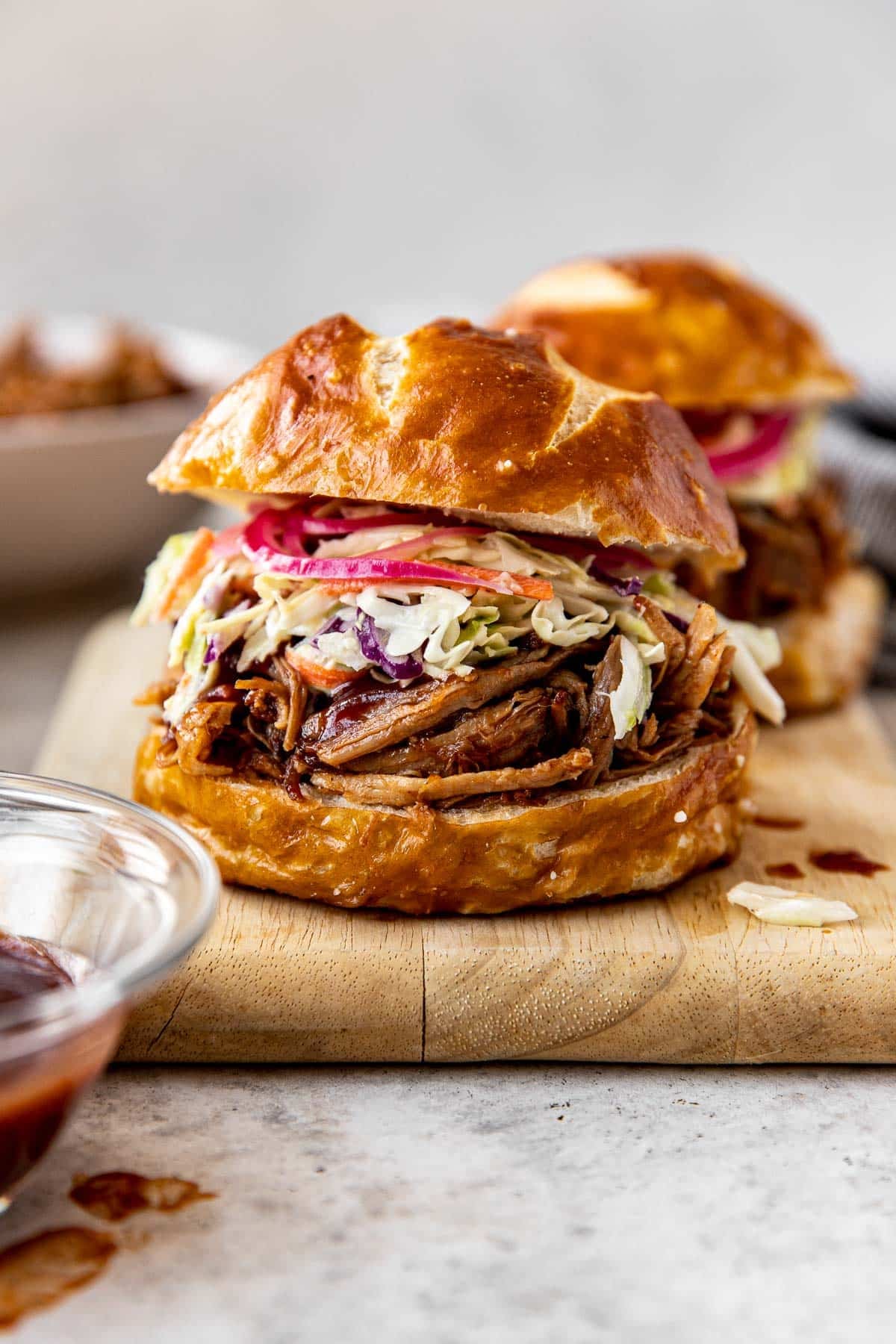 a pulled pork sandwich with slaw and pickled onions. 