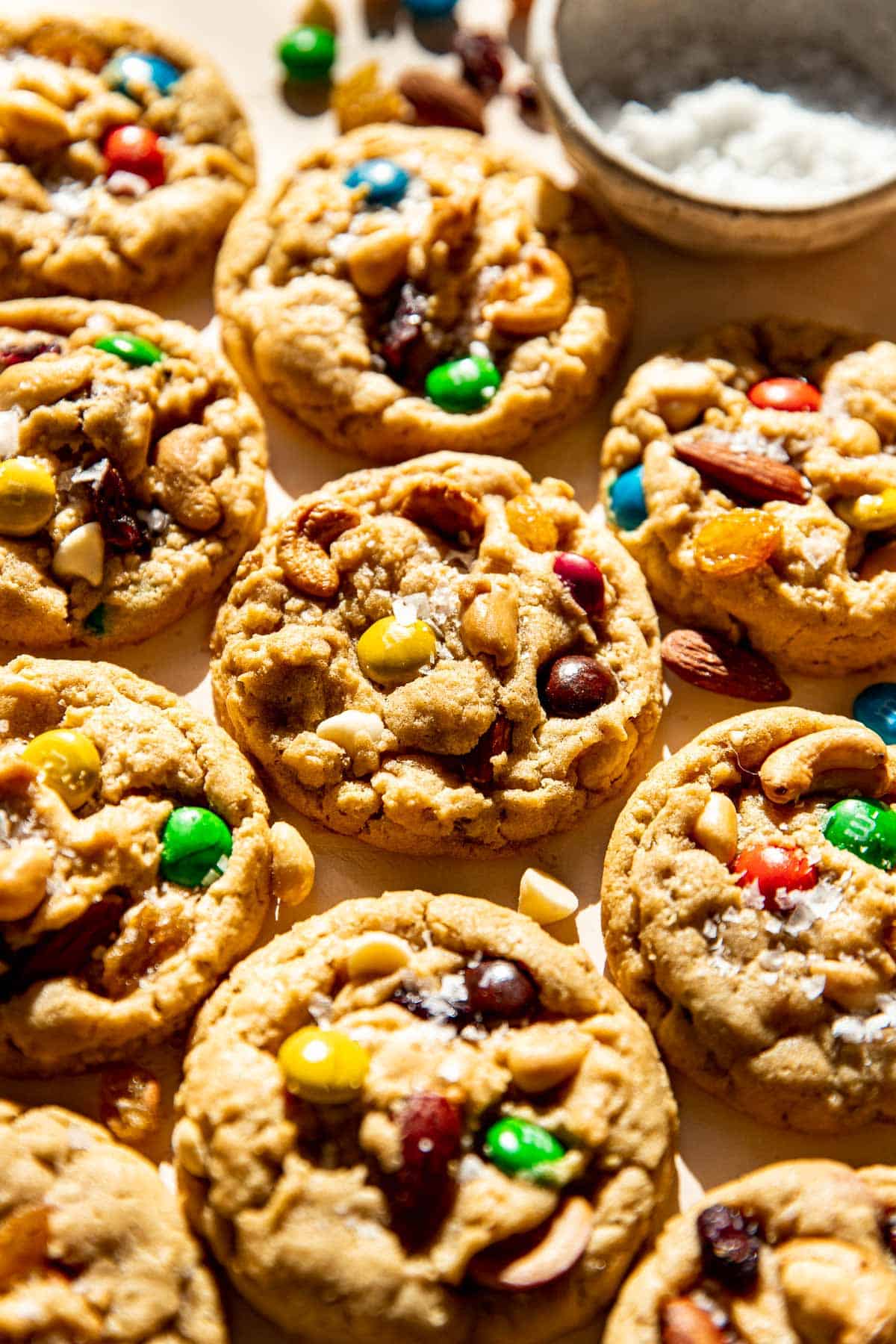 trail mix cookies garnished with flaky sea salt.