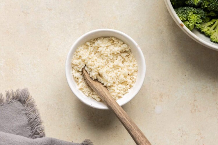 Panko breadcrumbs mixed with half and half in a small white bowl.