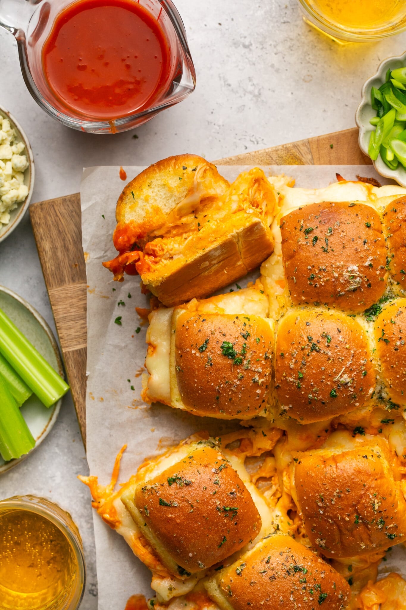 buffalo sliders made with chicken on a cutting board. 