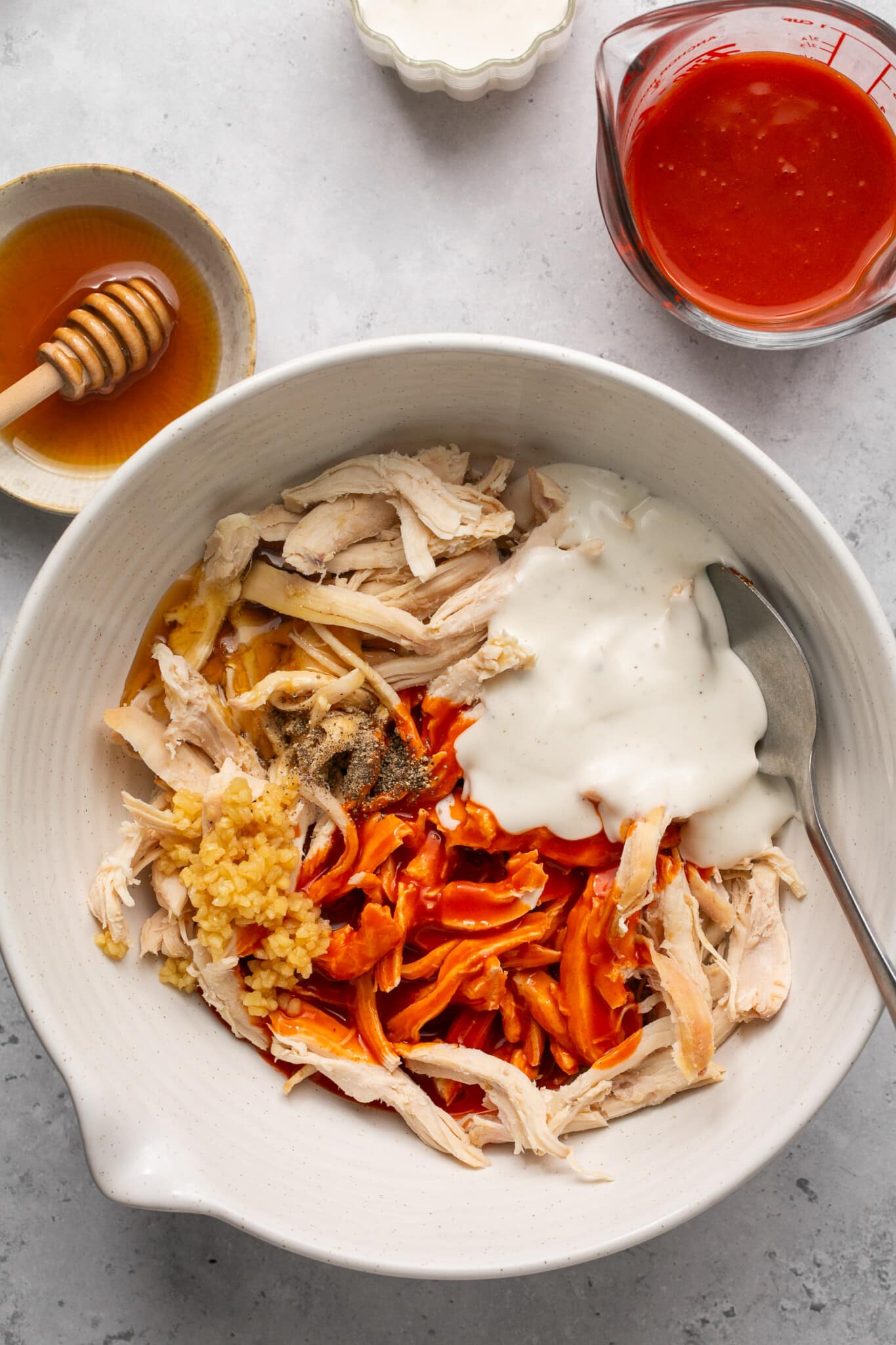 chicken, buffalo sauce, garlic, ranch and honet in a mixing bowl. 
