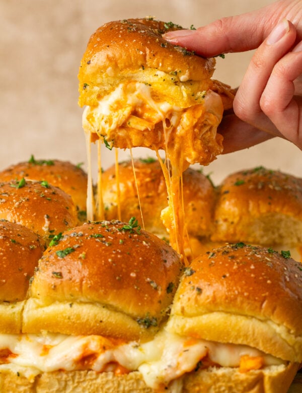 a hand holding a buffalo chicken slider.