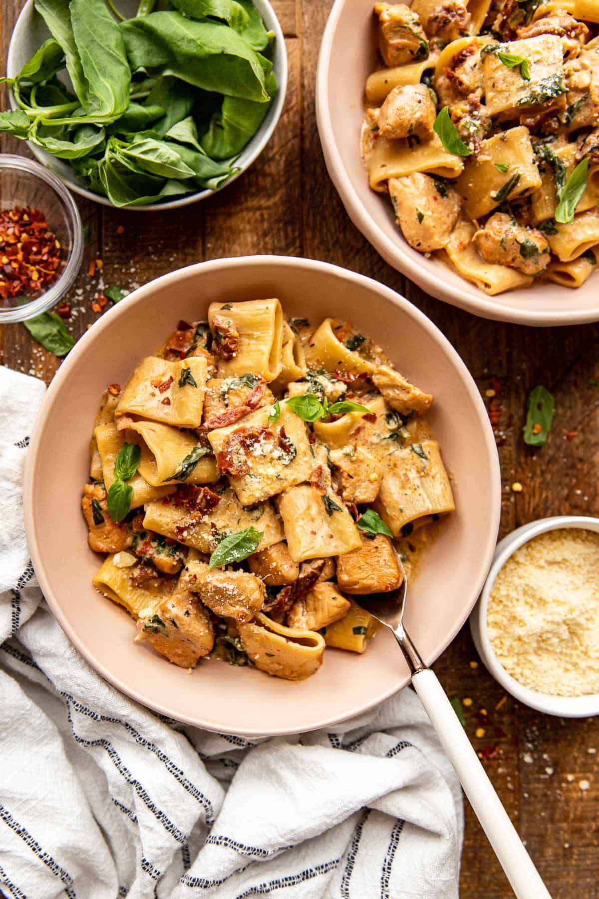 Marry me chicken pasta in a bowl with a fork in the bowl.