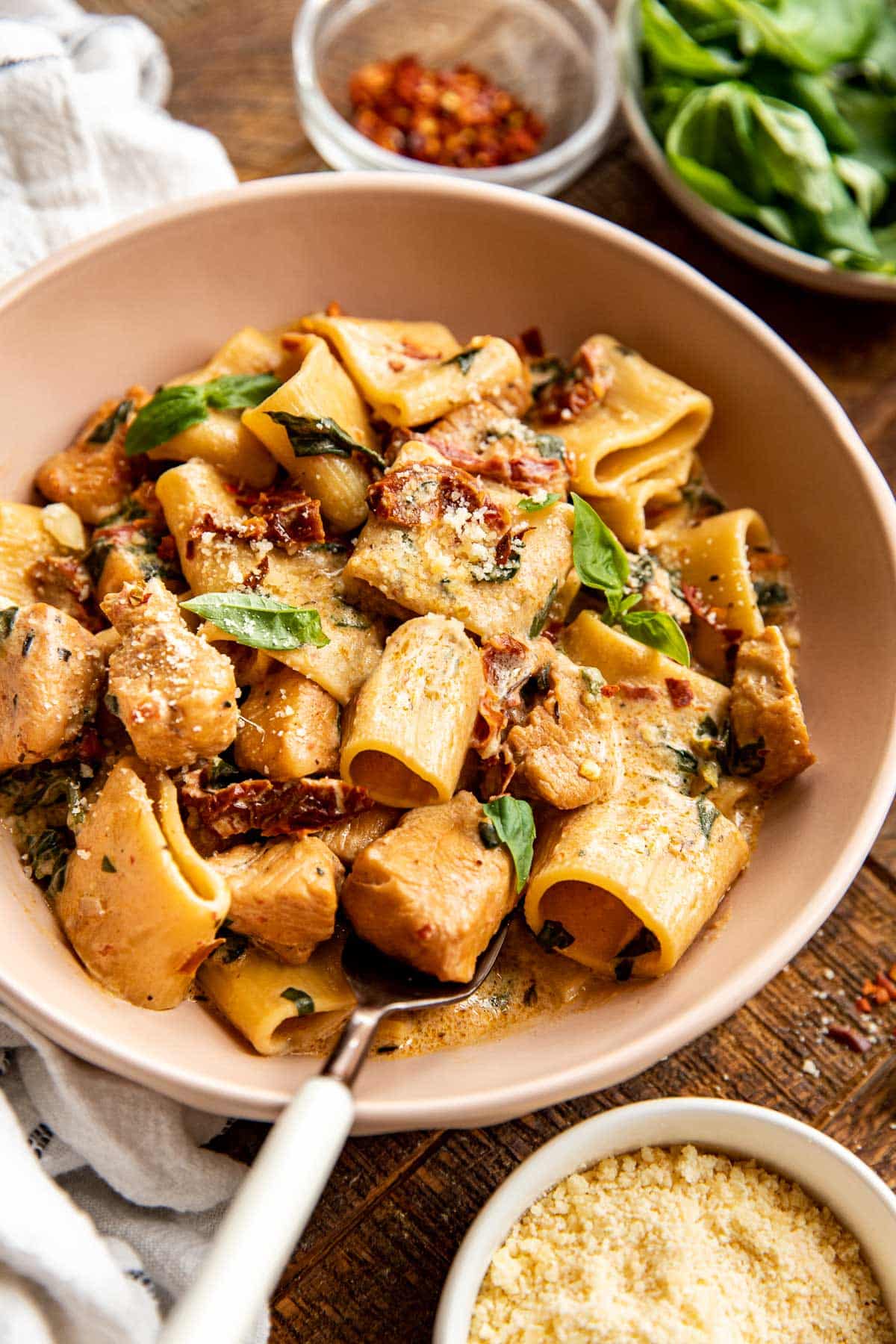 Marry me chicken pasta in a bowl with a fork in the bowl.