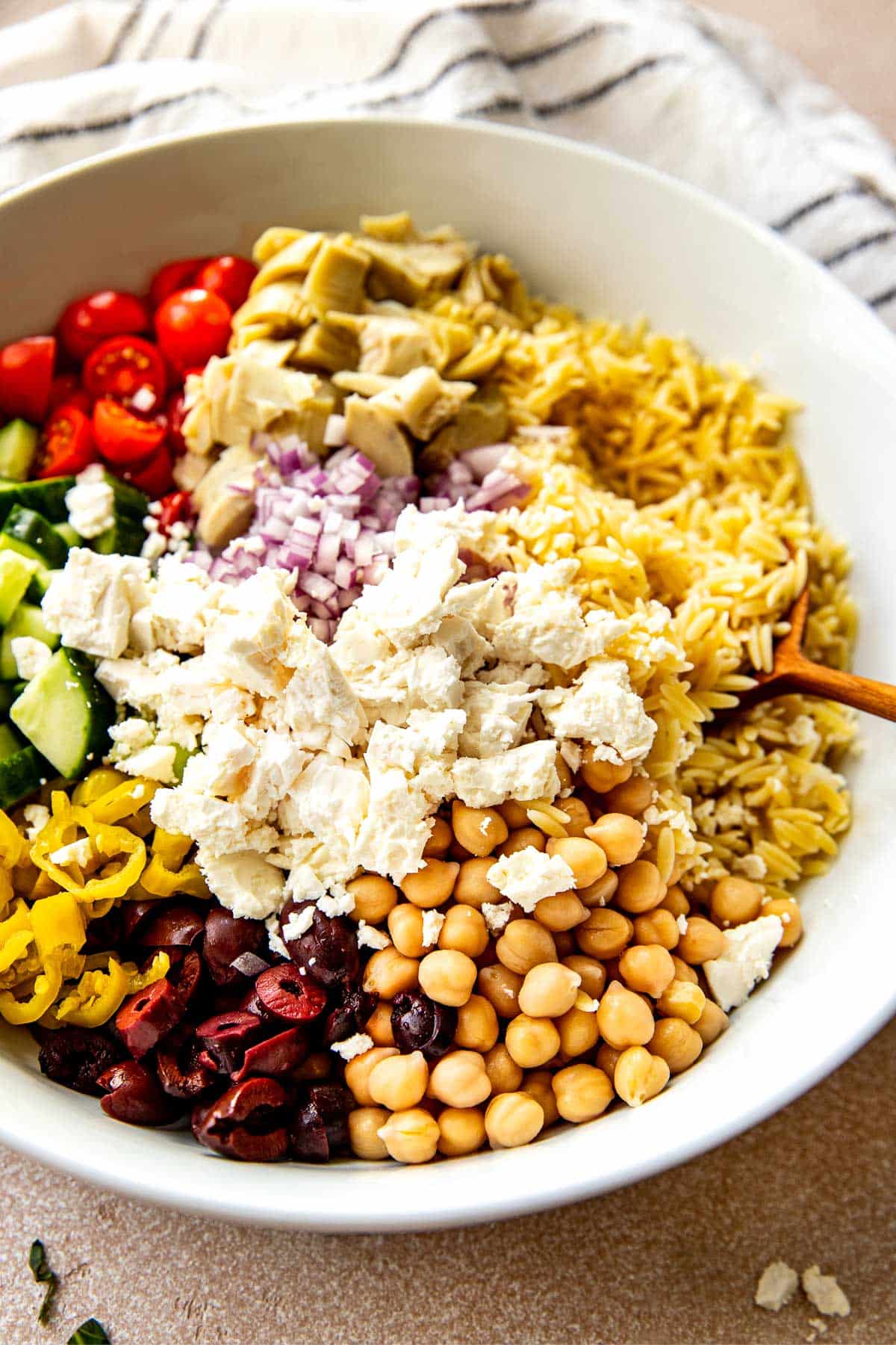 orzo salad in a large white bowl.