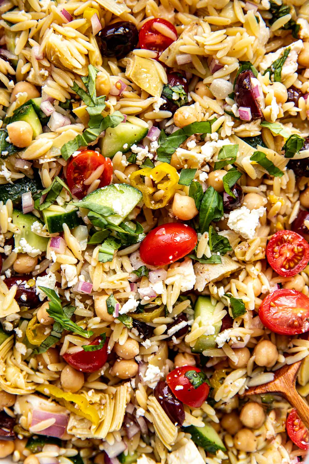 a close up image of orzo salad. 