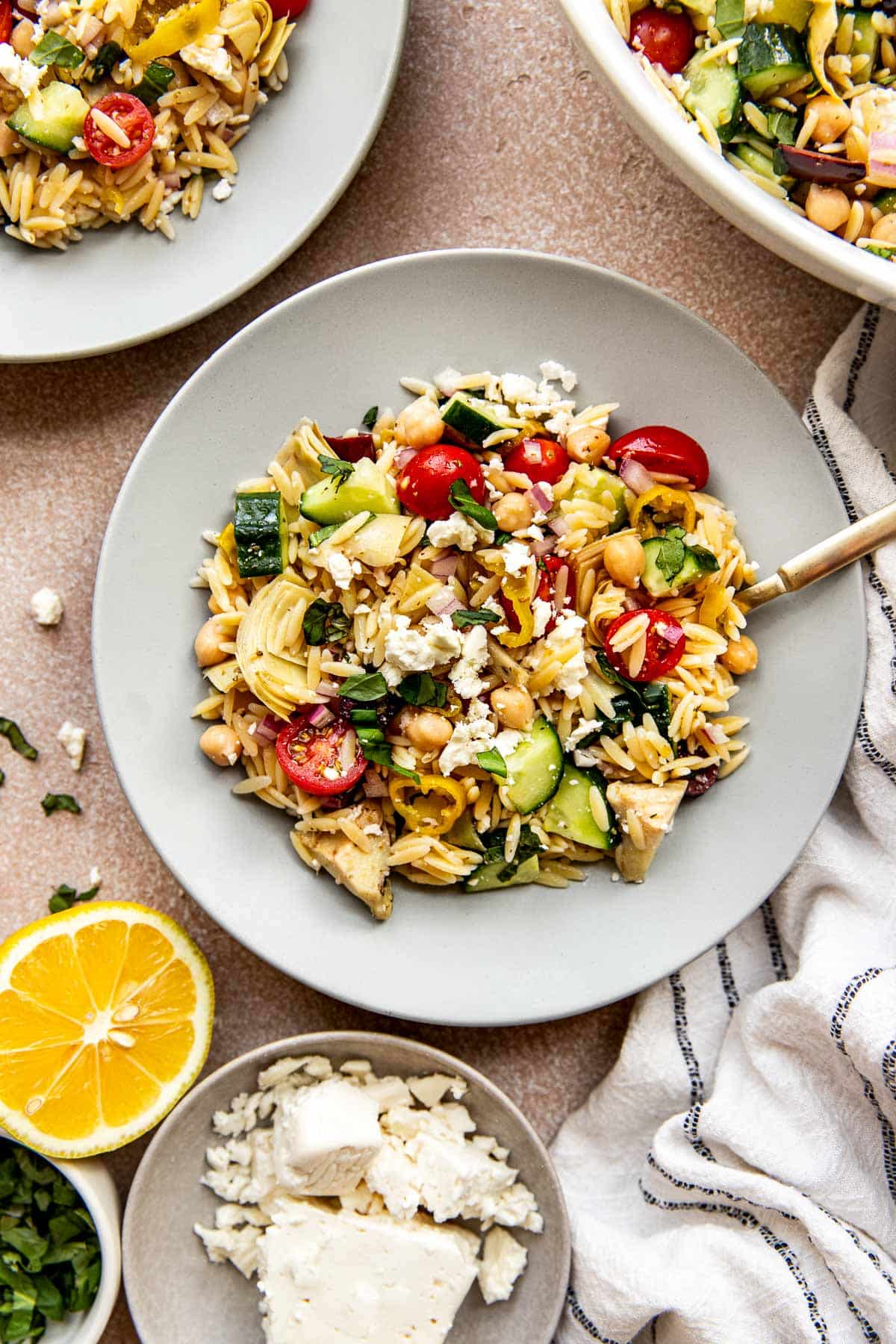 orzo salad on a grey plate. 