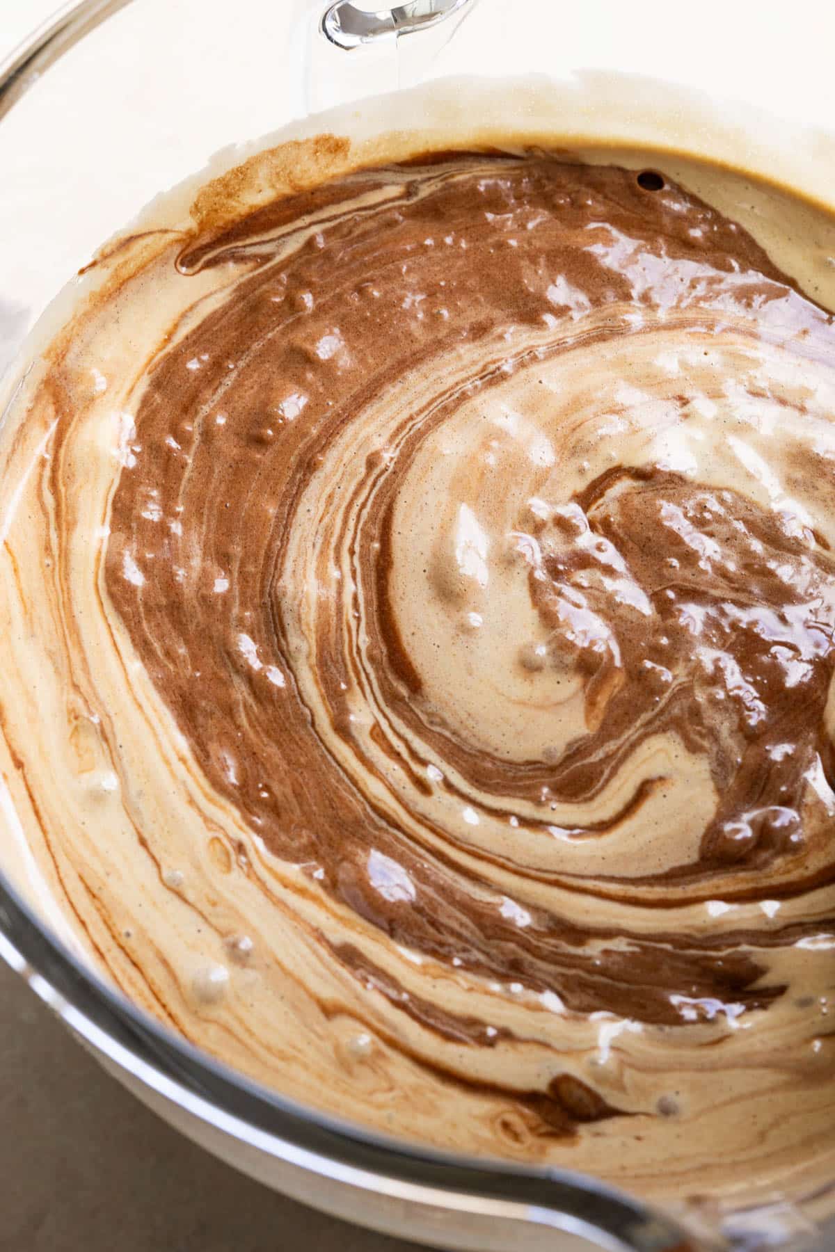 chocolate being stirred into egg and sugar mixture. 