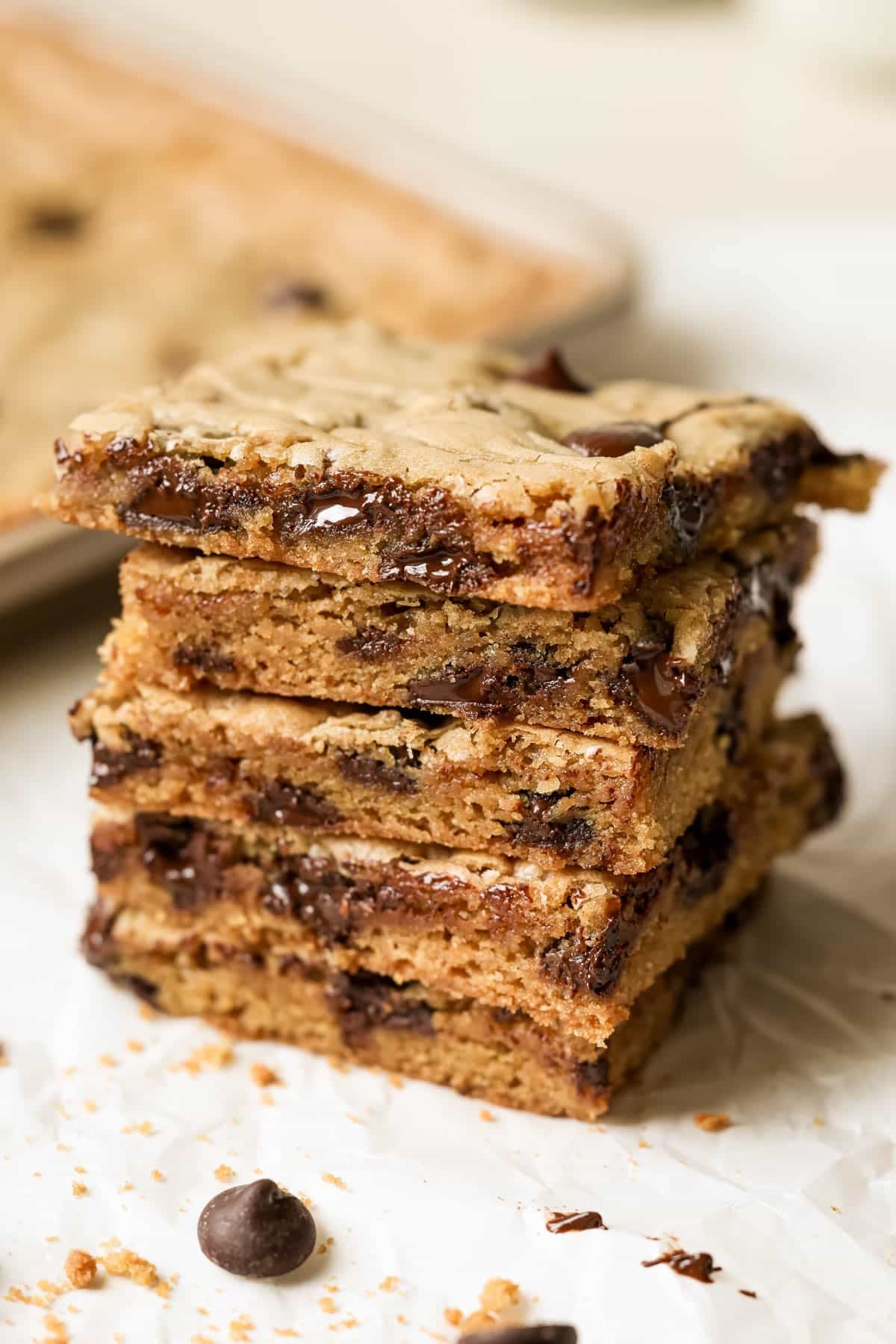 stacked sheet pan cookies with gooey melty chocolate chips. 