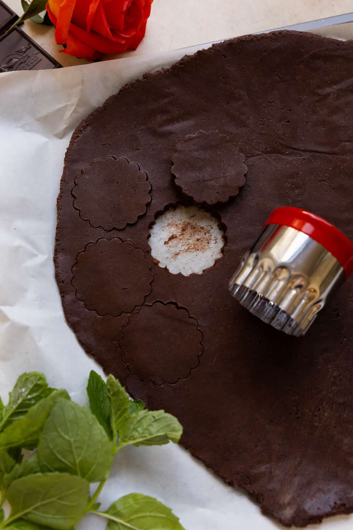 a cookie cutter cutting out cookies using a scalloped wavy cookie cutter. 