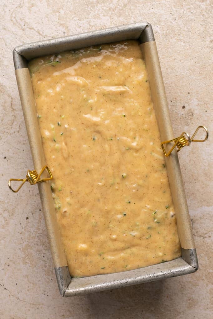 banana bread batter poured into a loaf pan. 