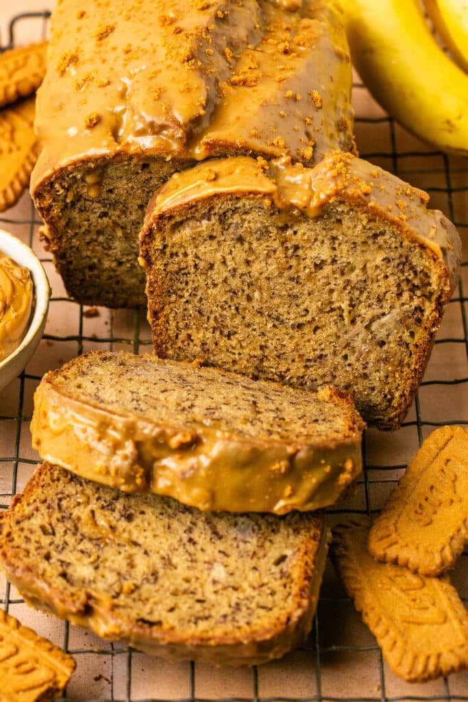 a slice of banana bread on a wire cooling rack. 