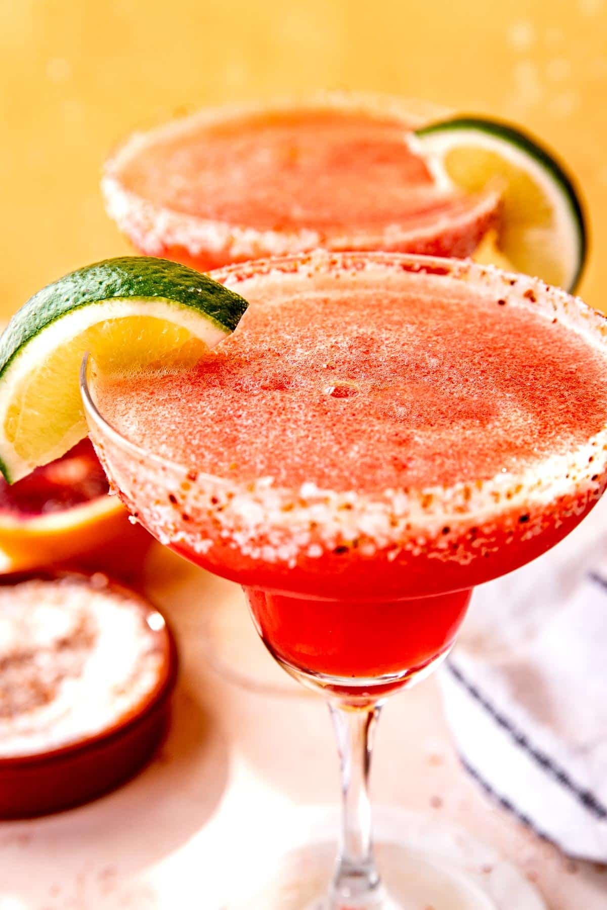 a blended blood orange margarita in a margarita glass. 