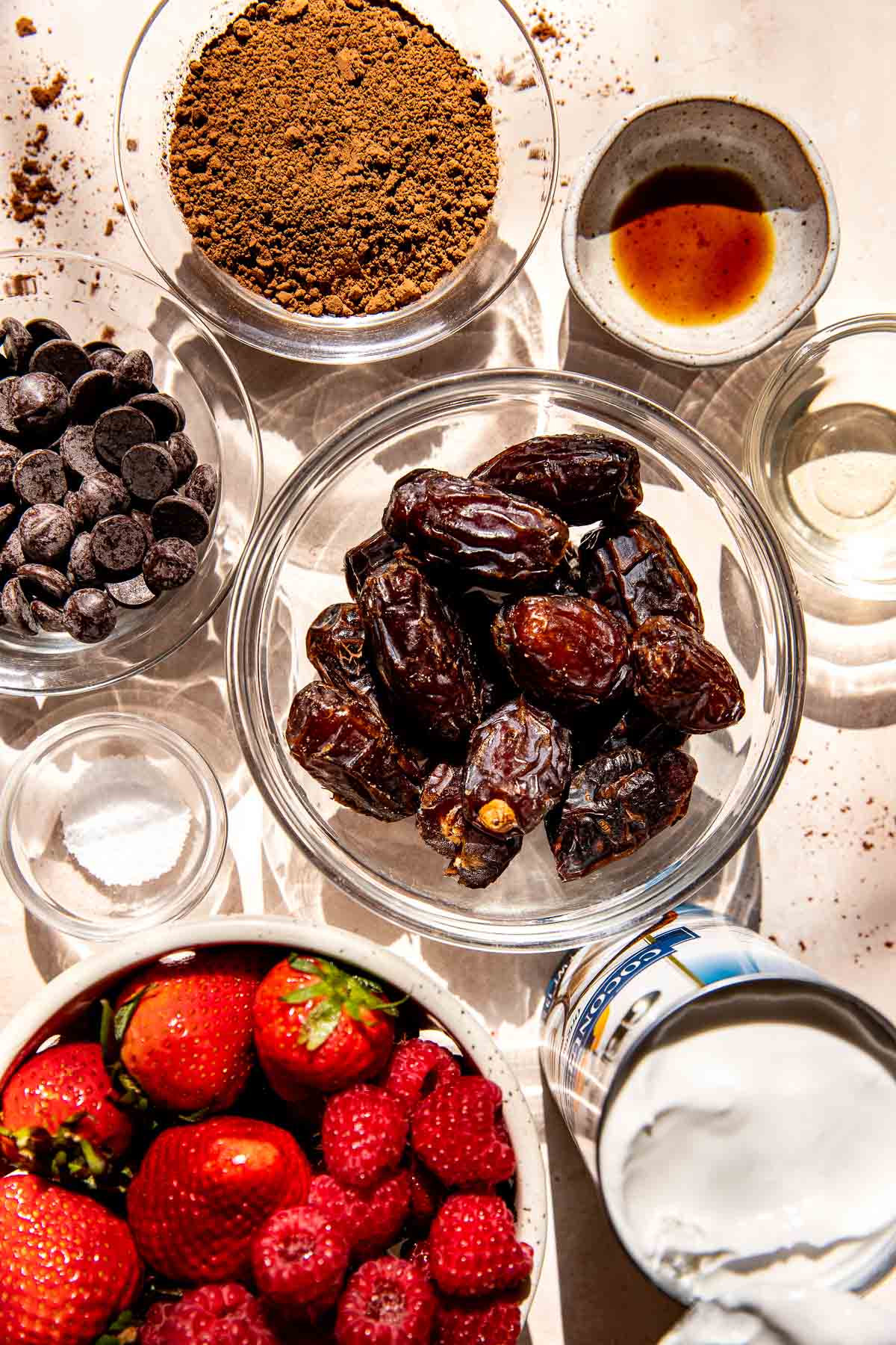 ingredients in small glass bowls needed to make chocolate mousse. 