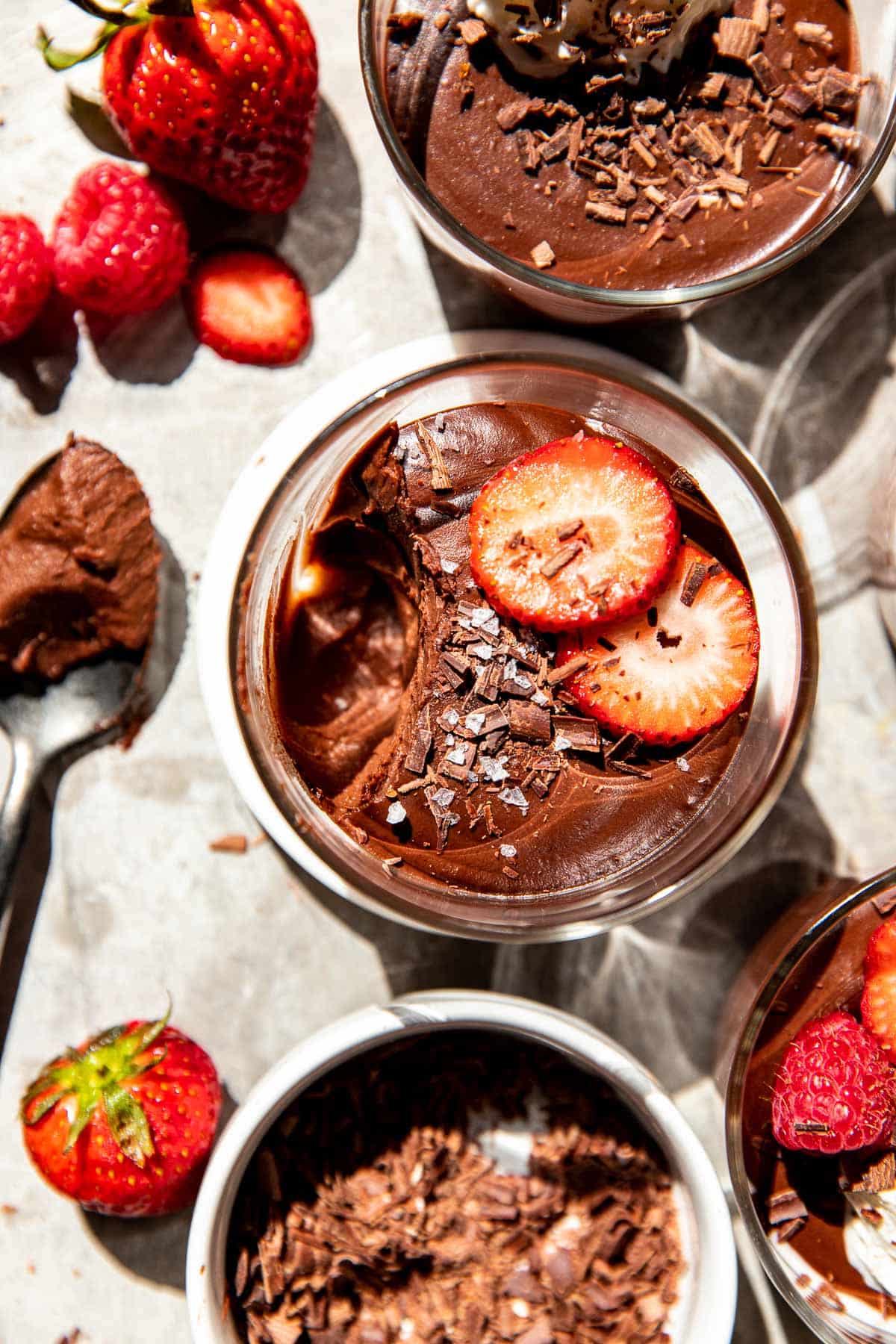 a spoon that has taken a bite out of chocolate mousse. 