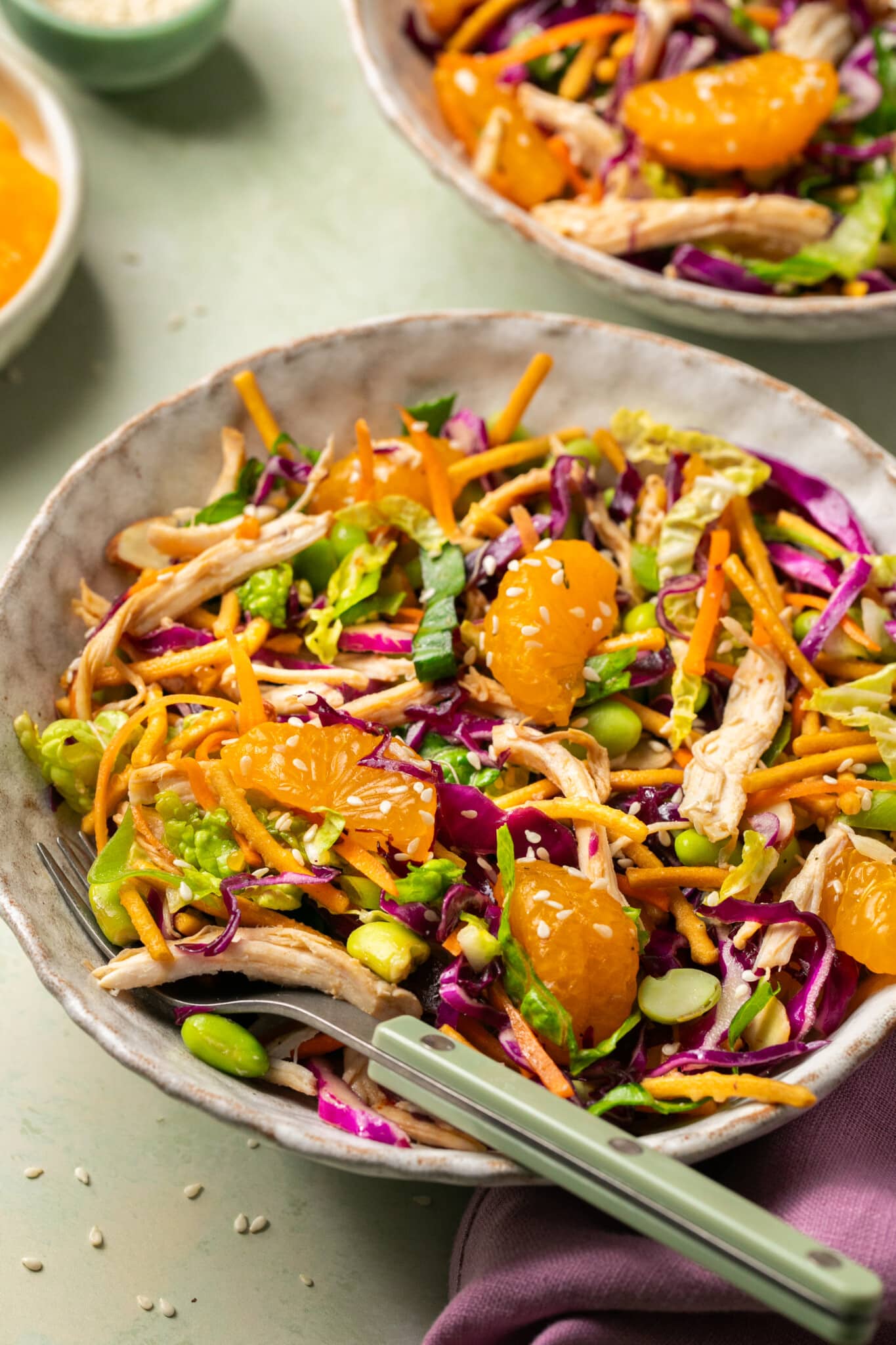 chopped chicken salad in a bowl with a fork.