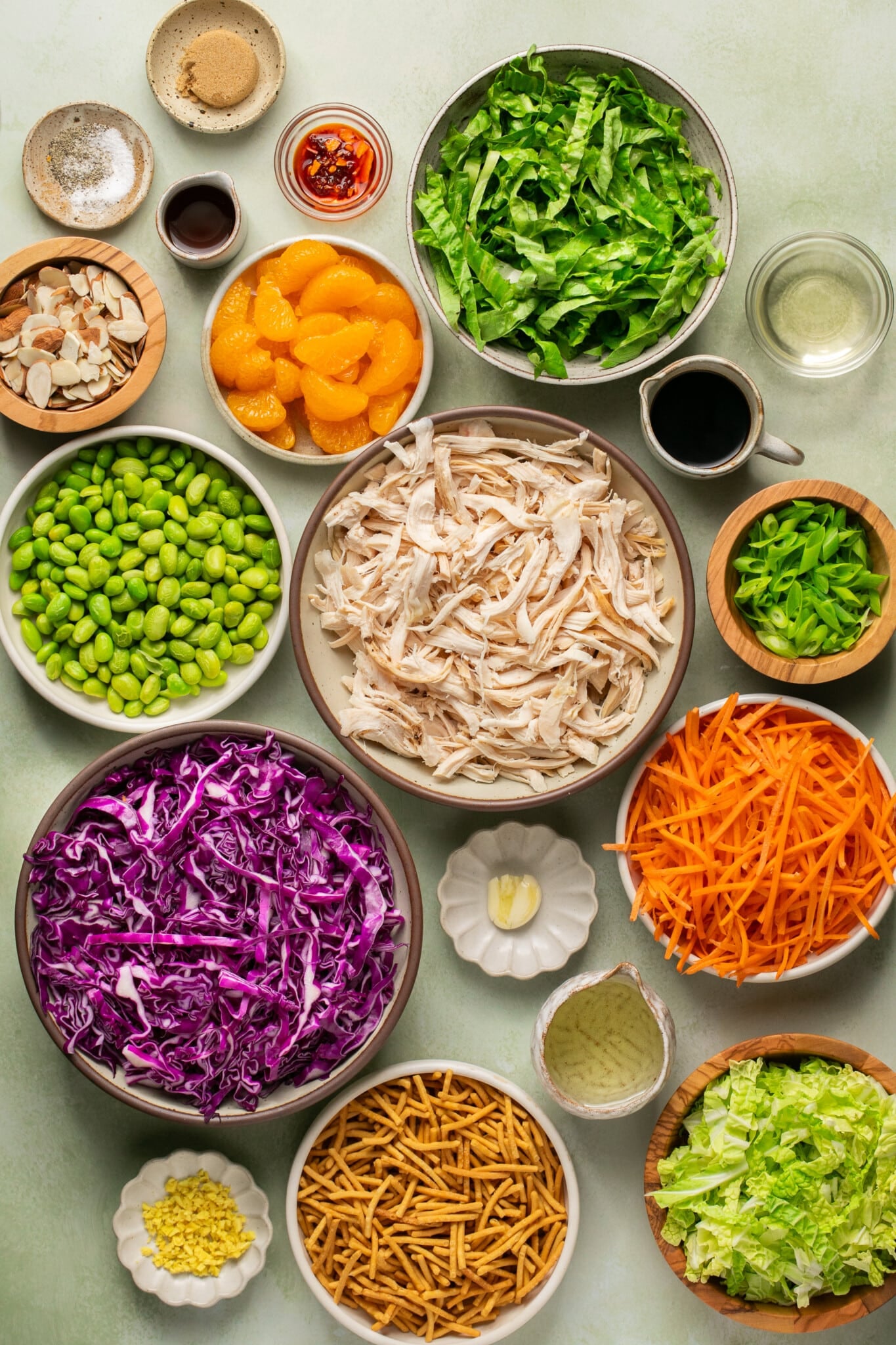 ingredients to make chopped chicken salad in small glass bowls.