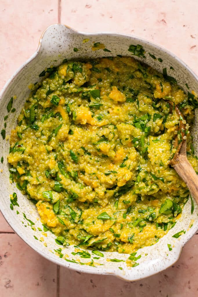 quinoa, cheese and eggs in a mixing bowl. 