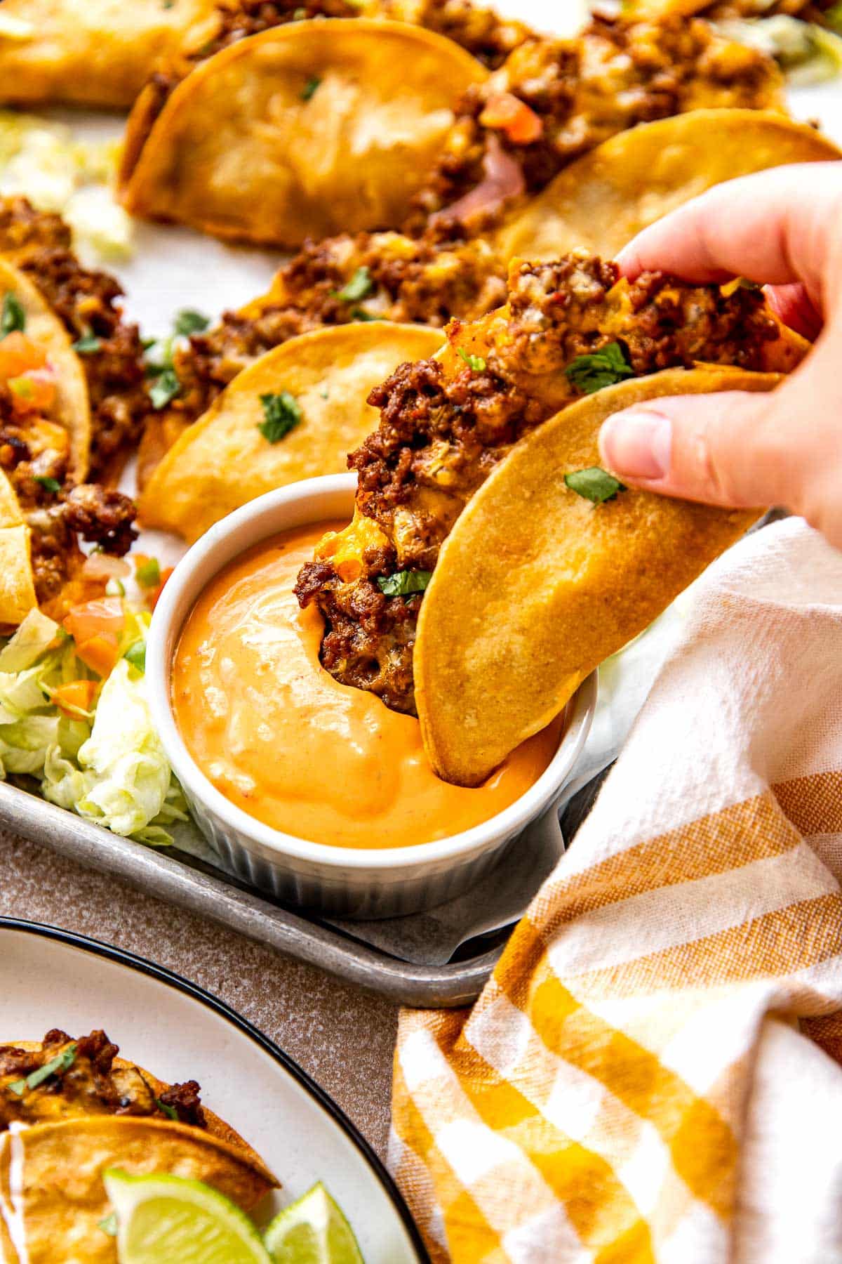 a taco being dunked into chipotle crema.