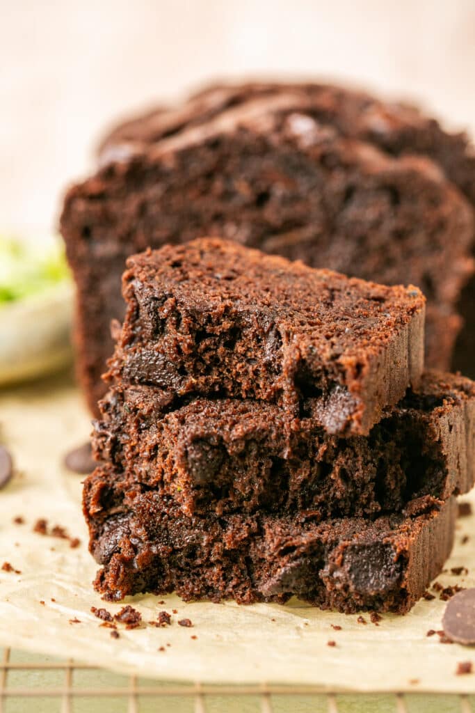 a slice of freshly baked double chocolate zucchini bread on parchment paper. 