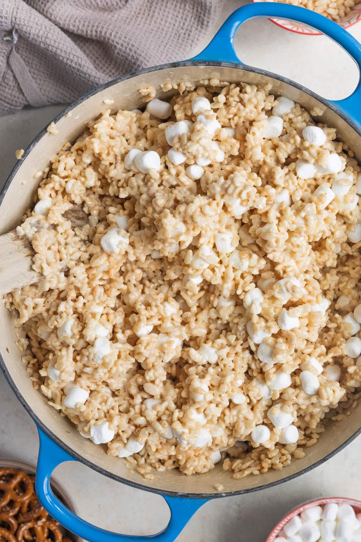 rice krispie treat mixture in a blue dutch oven. 
