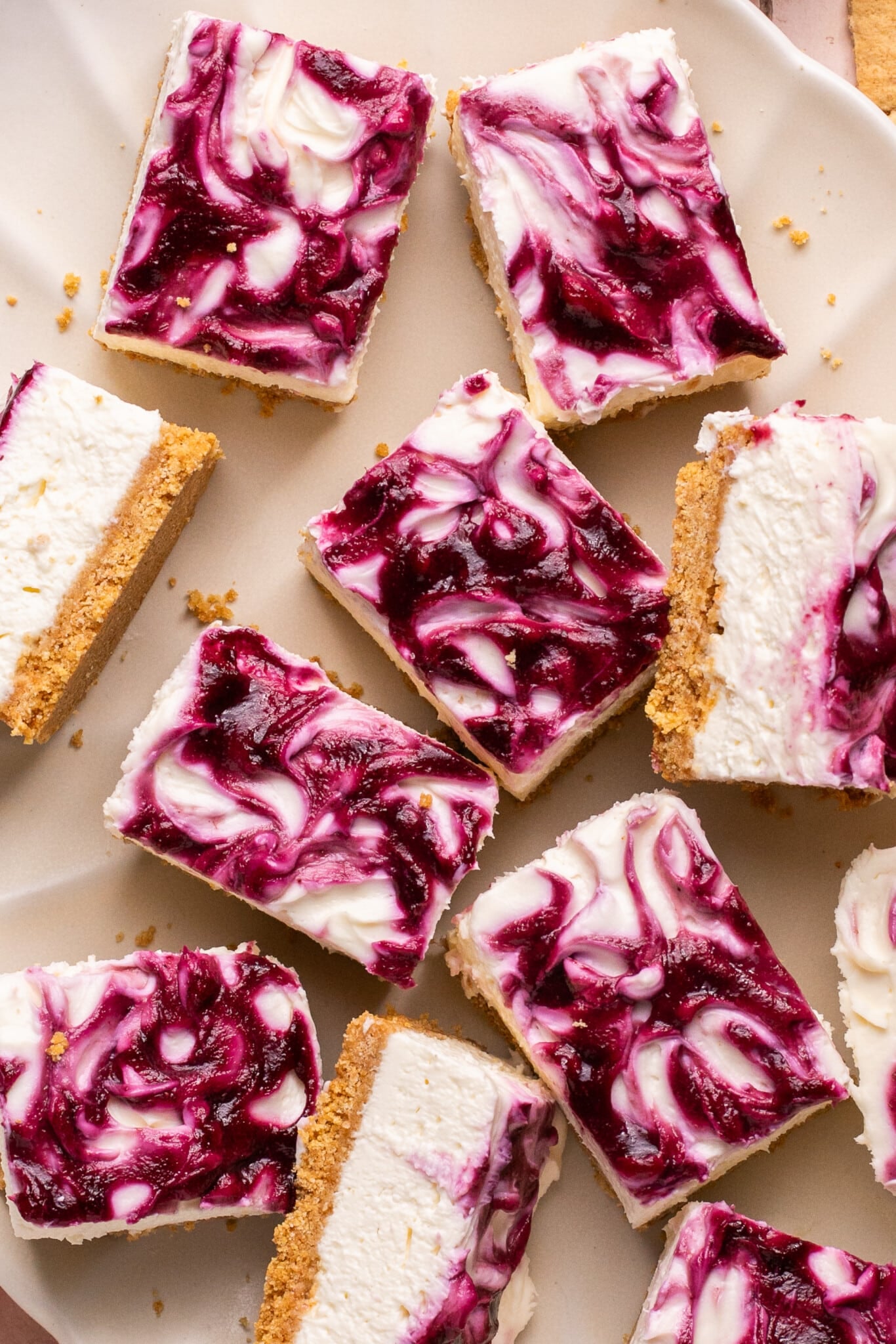 no bake cheesecake bars on a white plate.