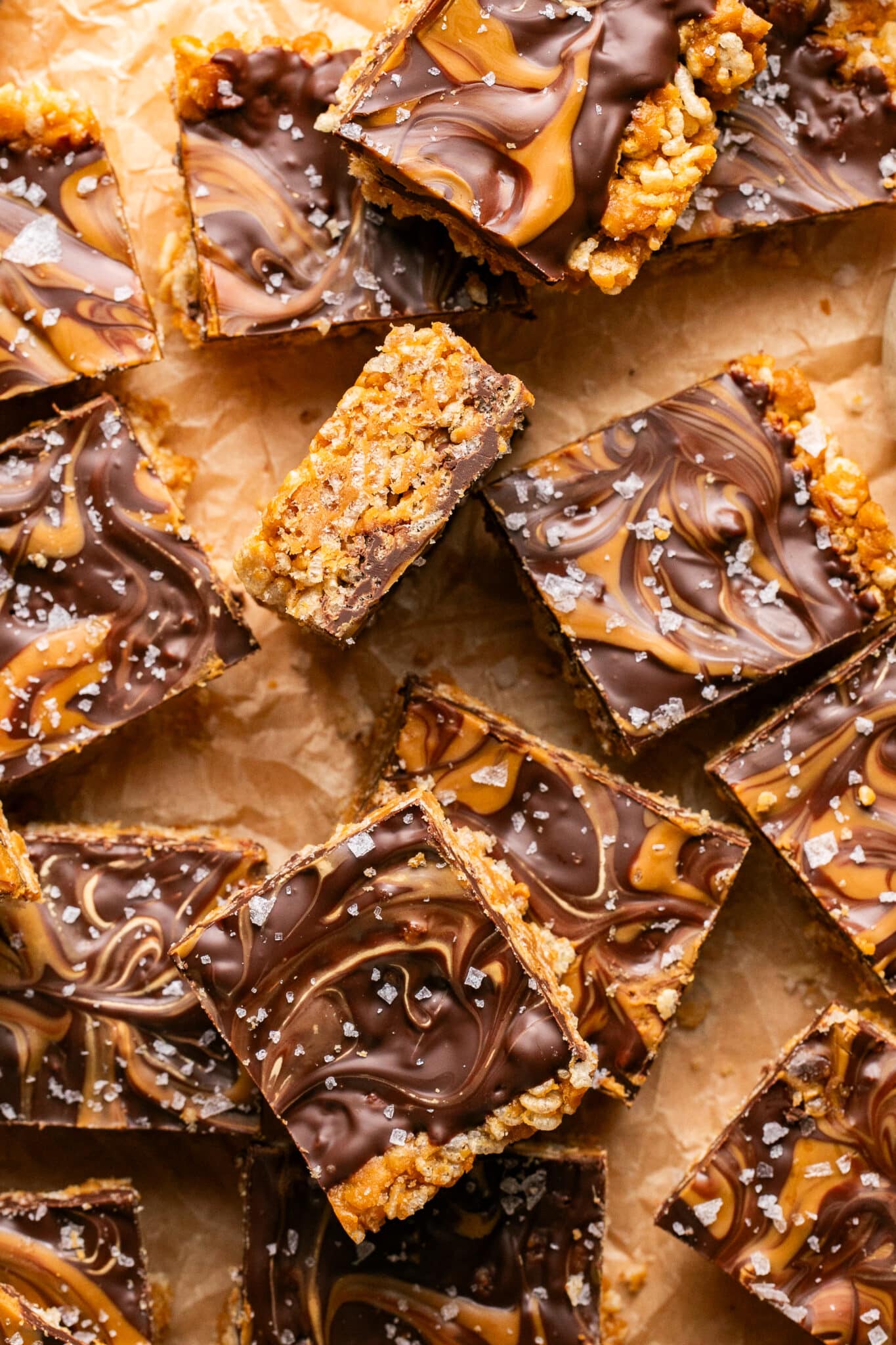 biscoff scotcheroos on parchment paper cut into squares.