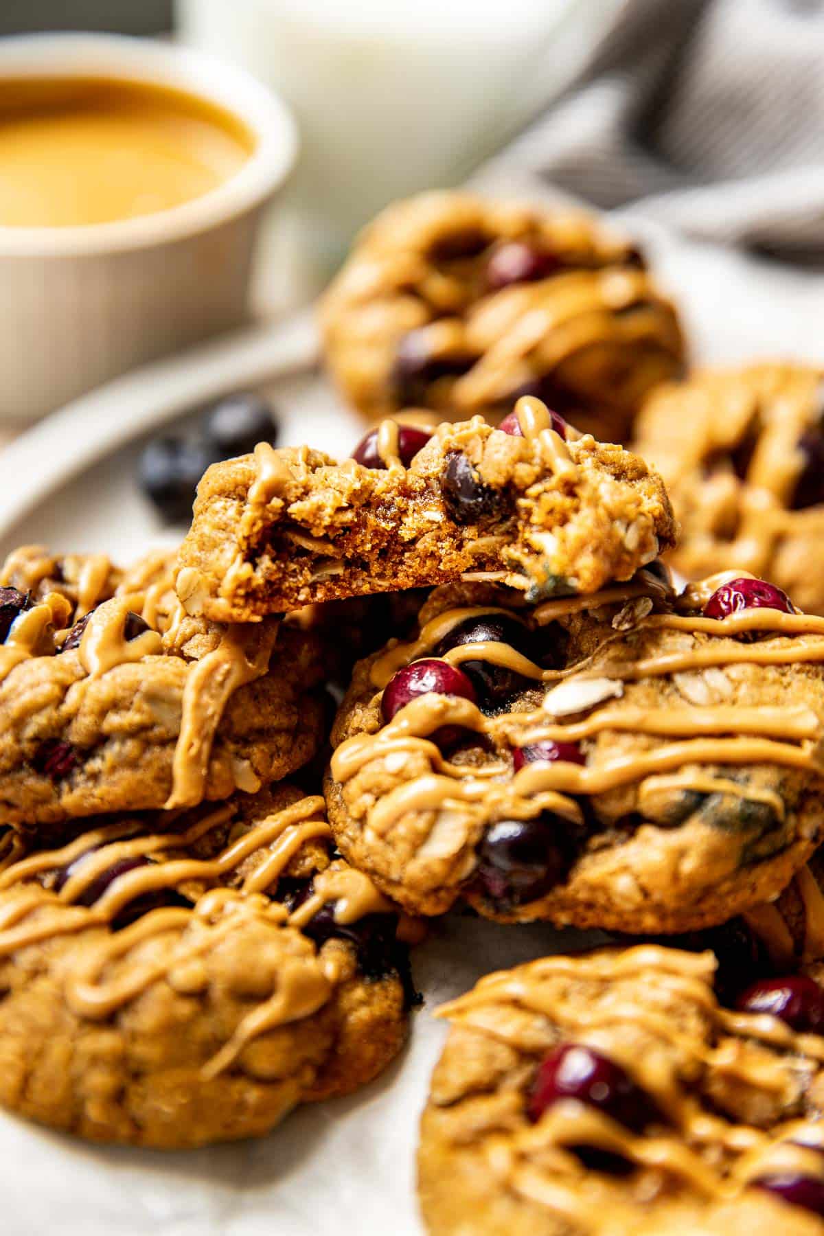 stacked peanut butter oatmeal cookies drizzled with peanut butter.