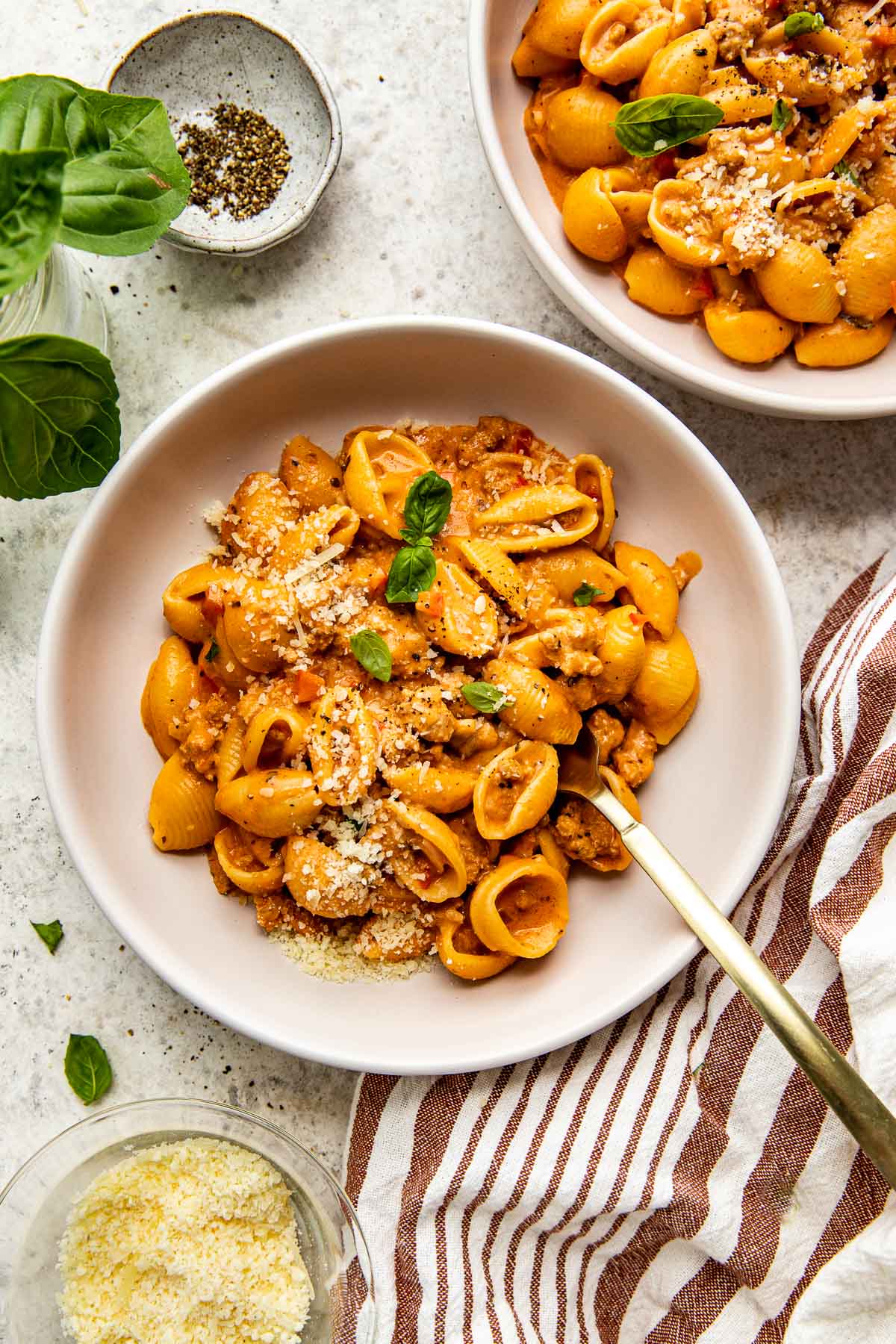 shell pasta in a white bowl. 