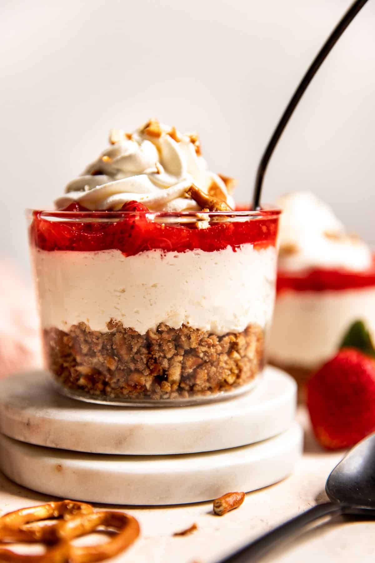 an up close image of strawberry pretzel salad in glass cups.