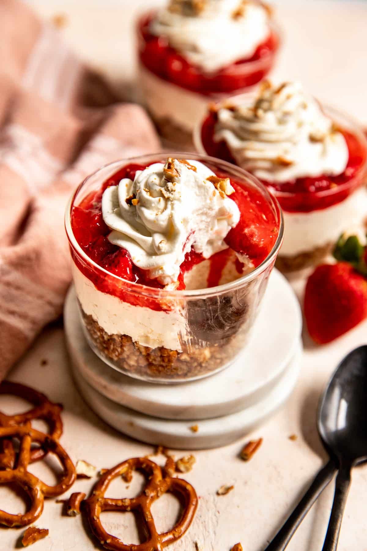 an up close image of strawberry pretzel salad in glass cups.