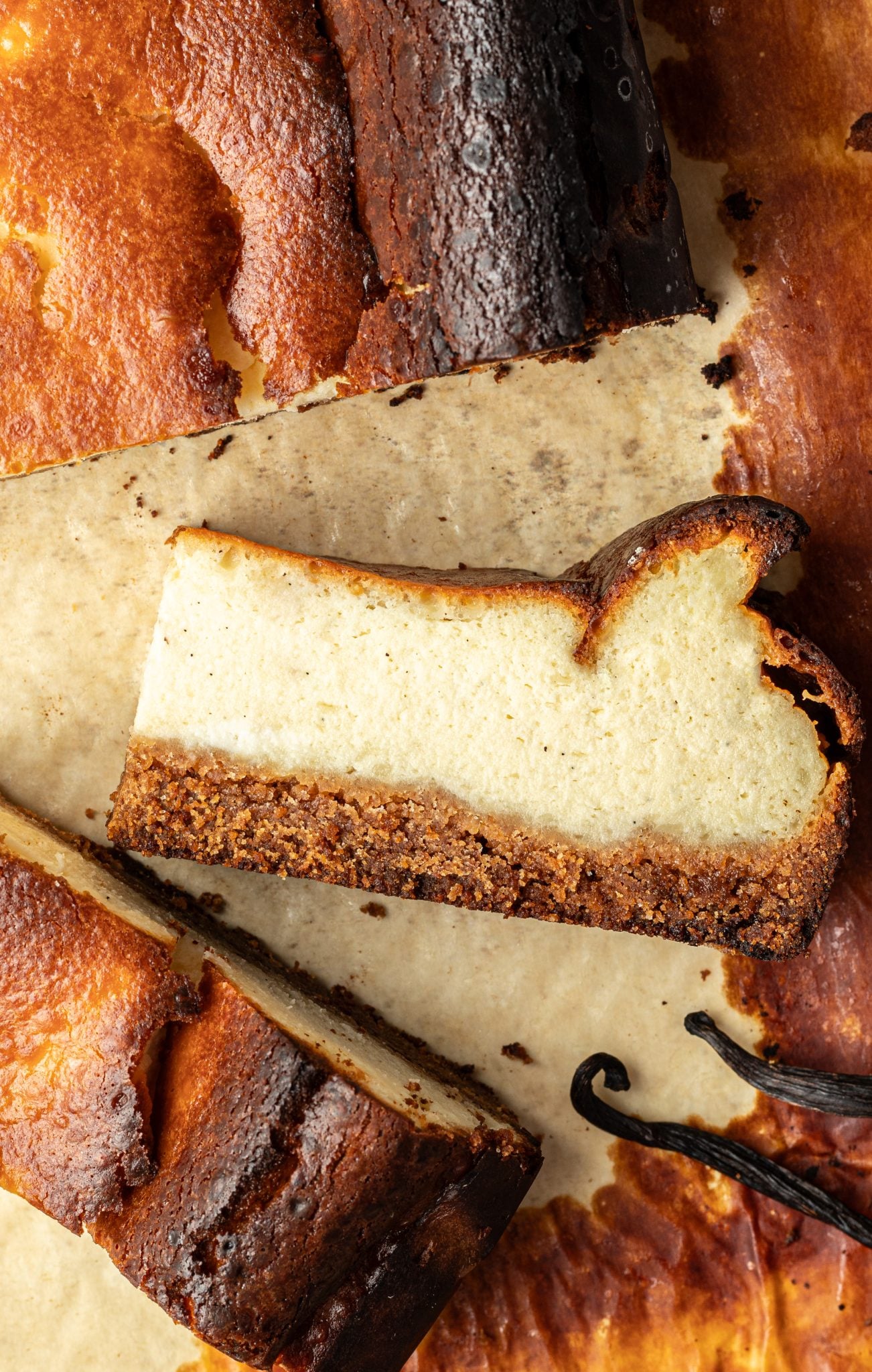 a slice of cheesecake on a piece of parchment paper.