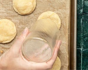 hand holding a clear up holding it over a cookie to maintain the circle shape