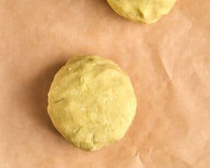 ball of cookie dough on brown parchment paper